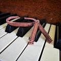 Upcycled Piano String Bracelets and Earrings Set on a piano 