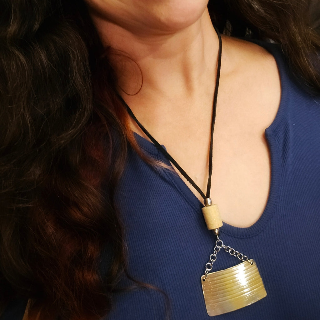 drummer girl wearing cymbal and drumstick black suede necklace