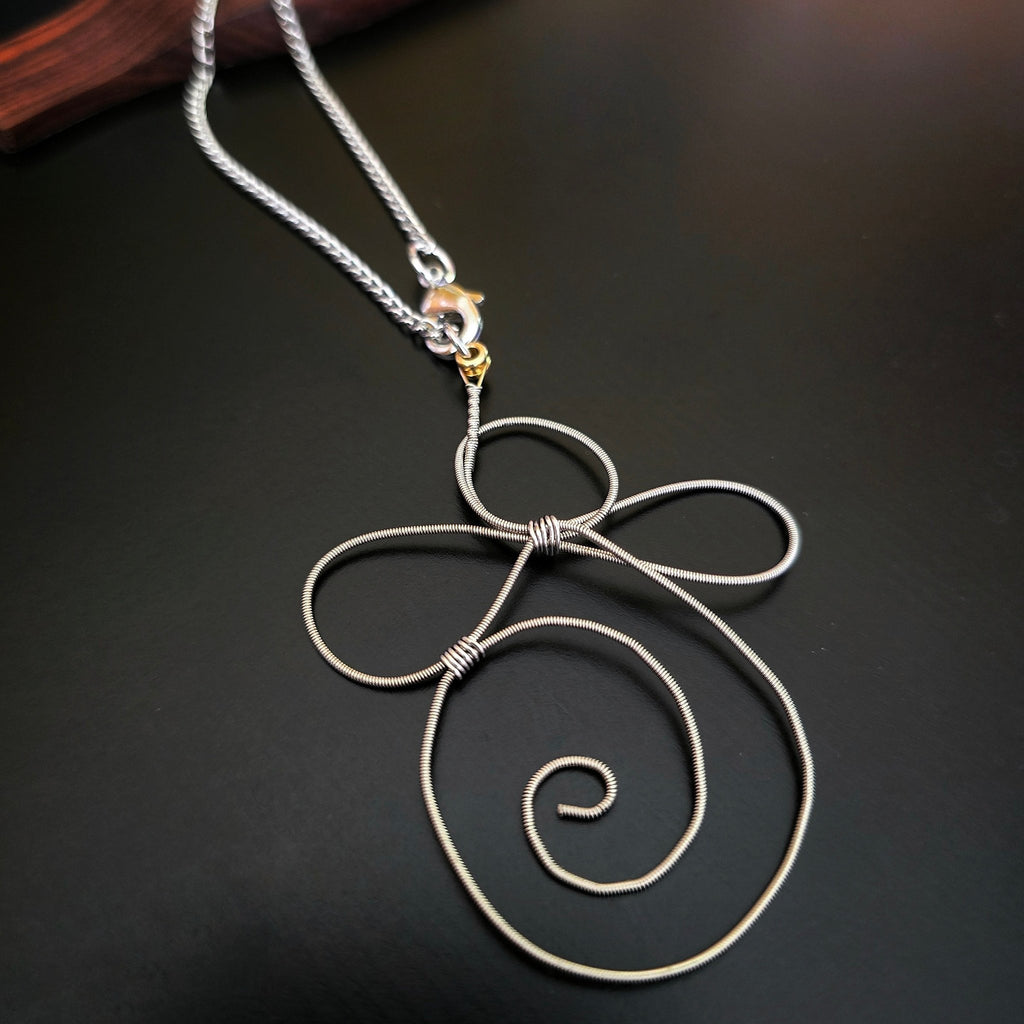 guitar string guardian angel on black guitar