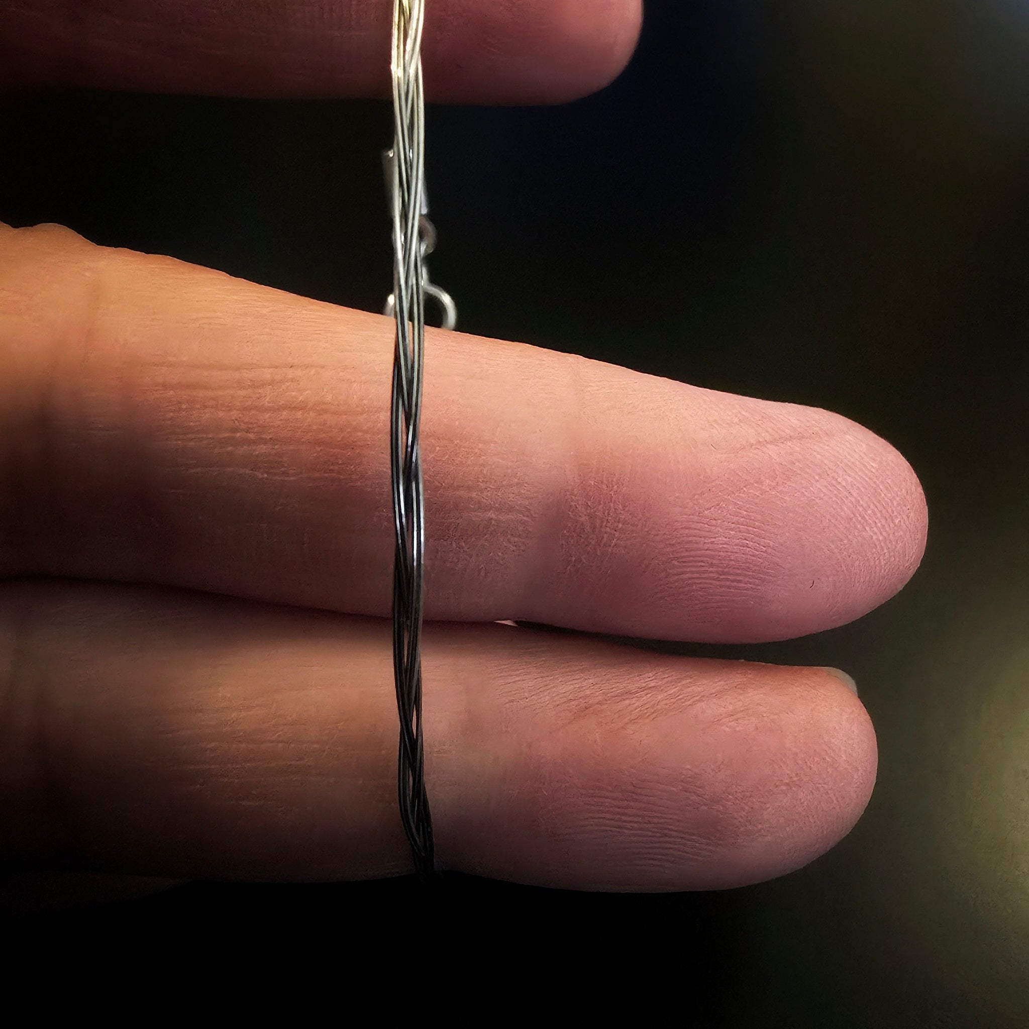 hand holding violin string bracelet