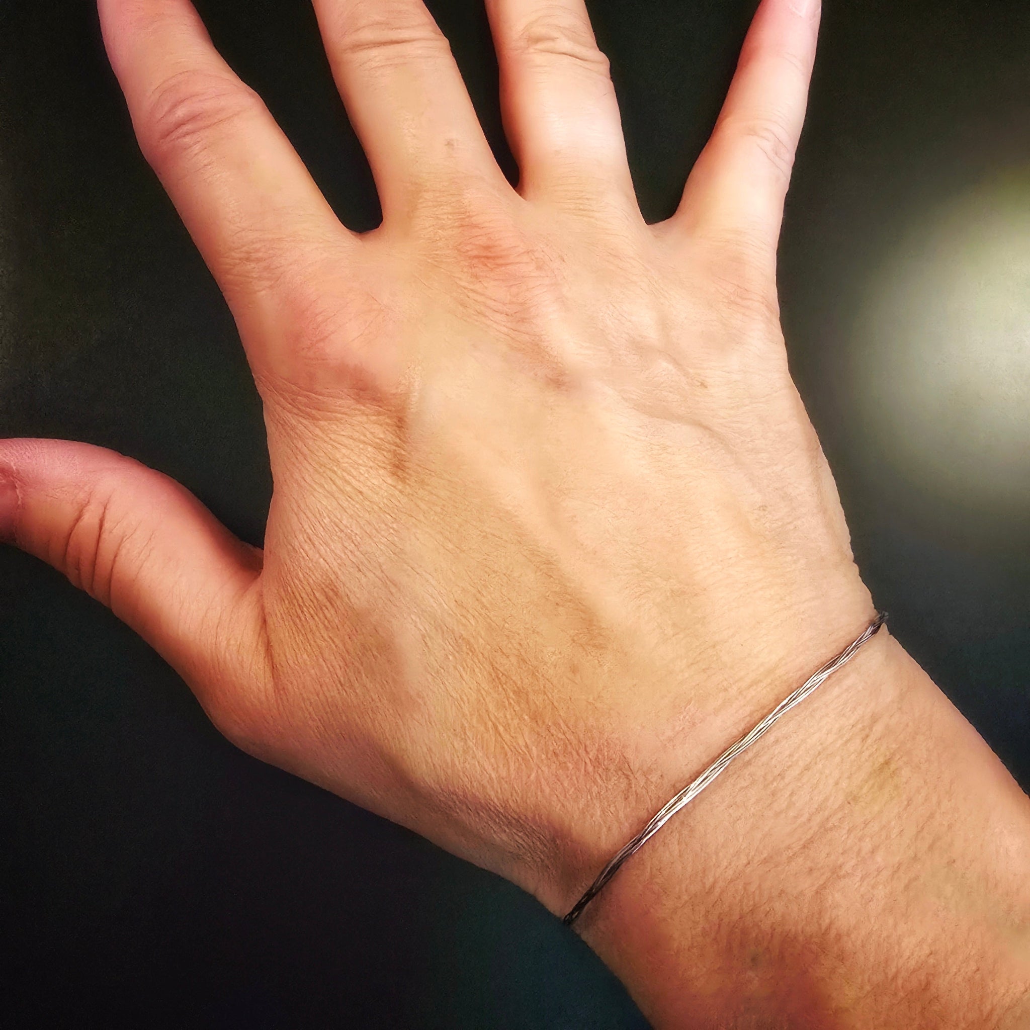 hand with violin string bracelet on wrist