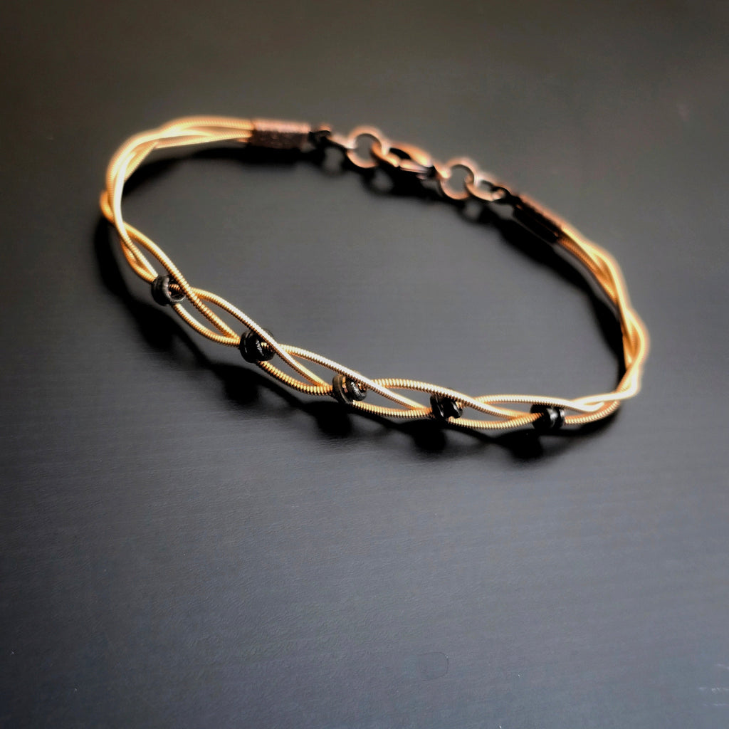 Braided Bronze Guitar String Black Ballend Unisex Bracelet on Black Backround