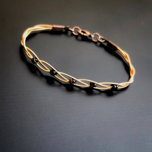 Braided Bronze Guitar String Black Ballend Unisex Bracelet on Black Backround