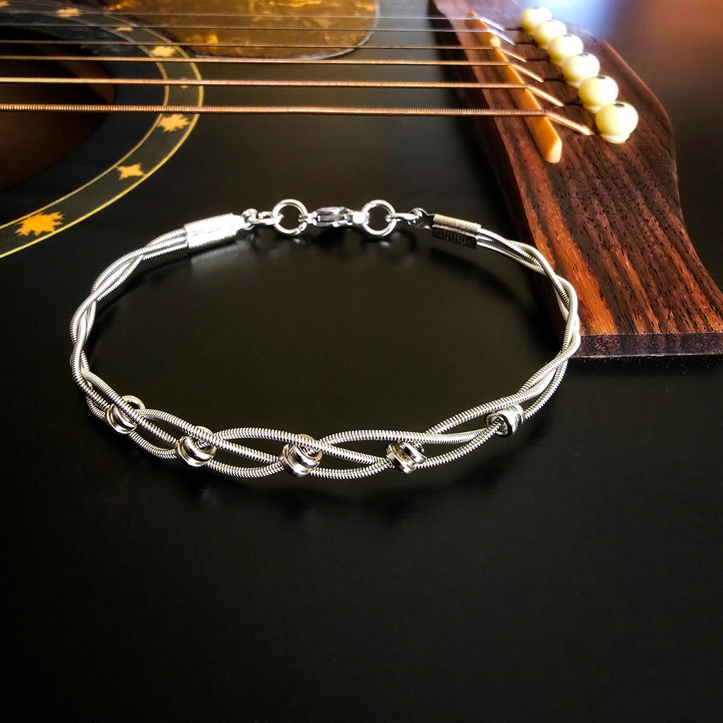 upcycled silver guitar string bracelet on guitar strings