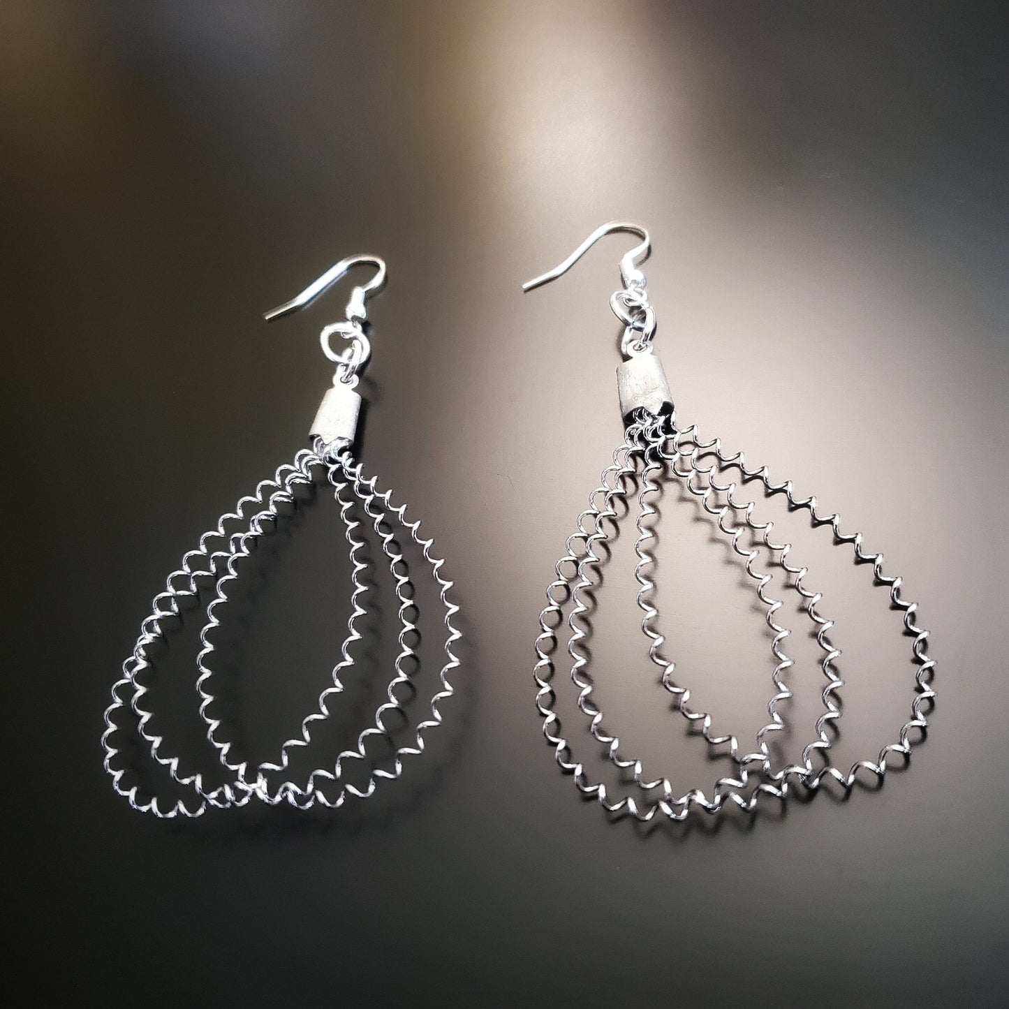 snare drum string teardrop style silver earrings