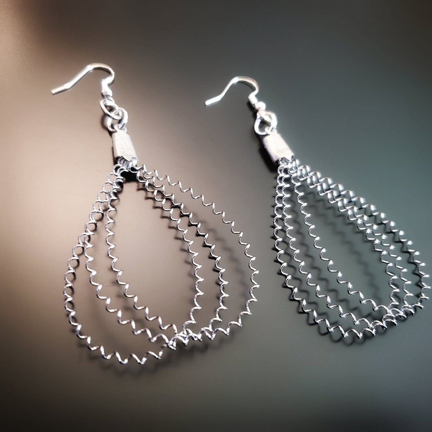 snare drum string teardrop style silver earrings