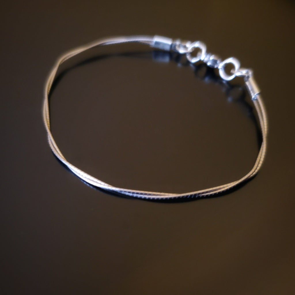 upcycled violin string bracelet black background