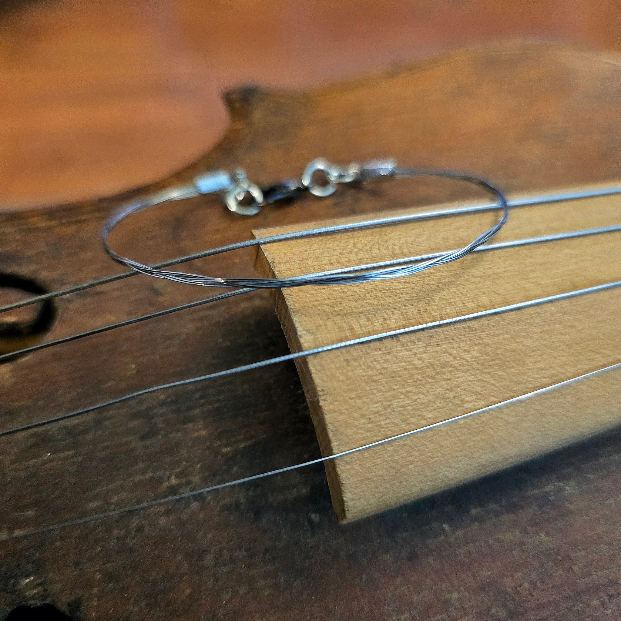 violin string bracelet on brown violin