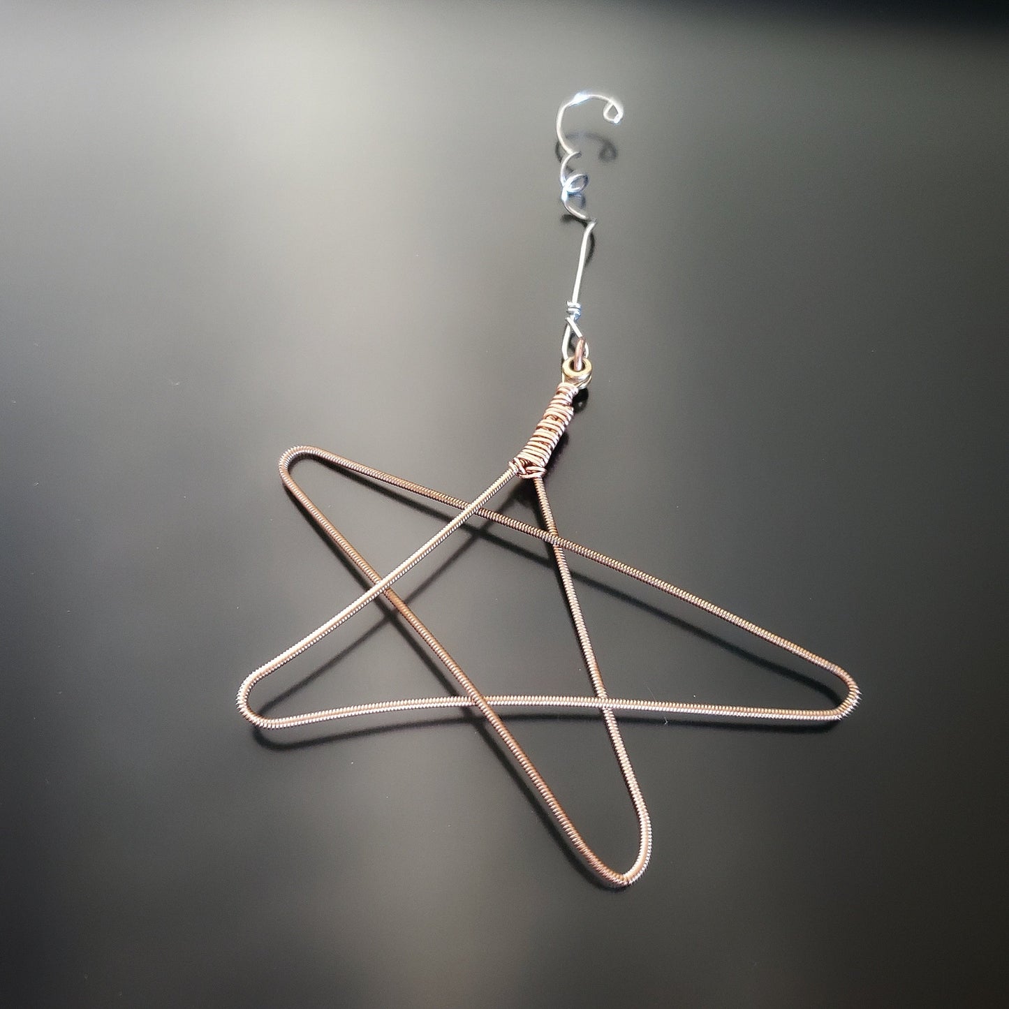 Christmas ornament in the shape of a star, made from an upcycled guitar string