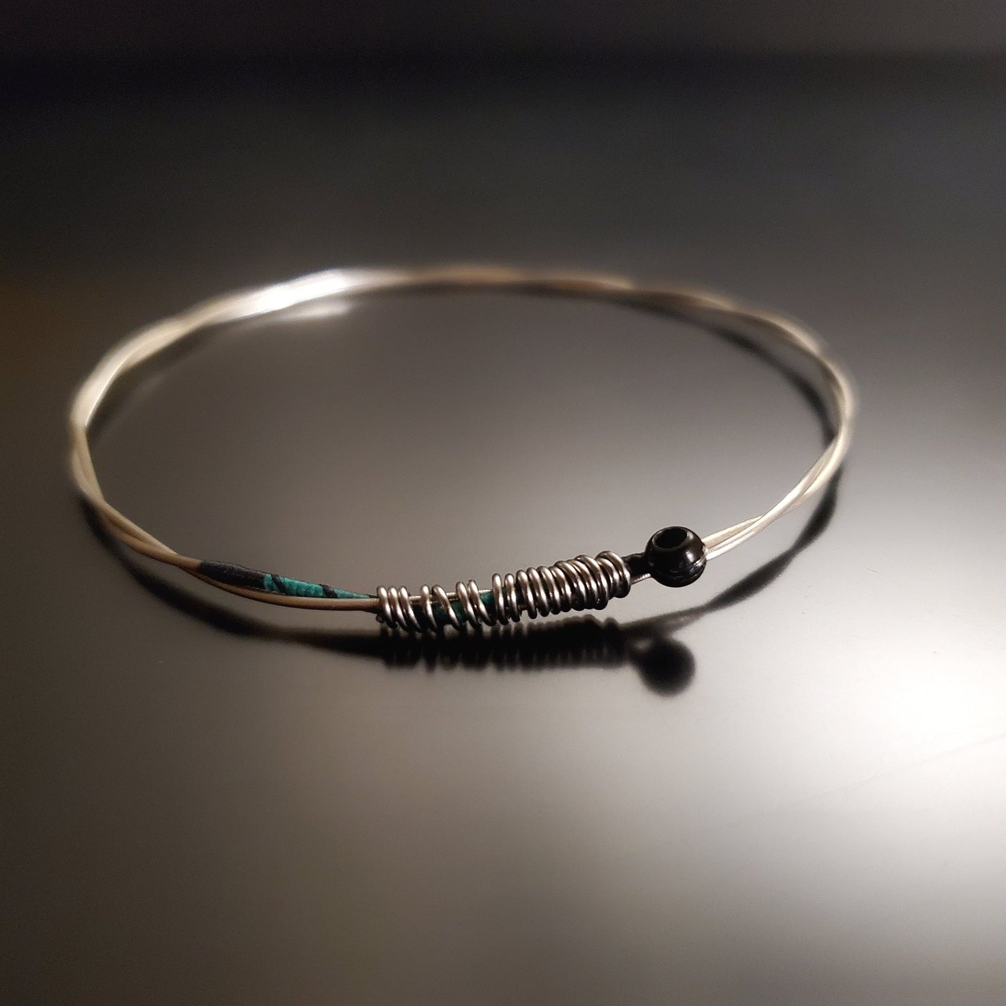 bangle style bracelet made from an upcycled violin