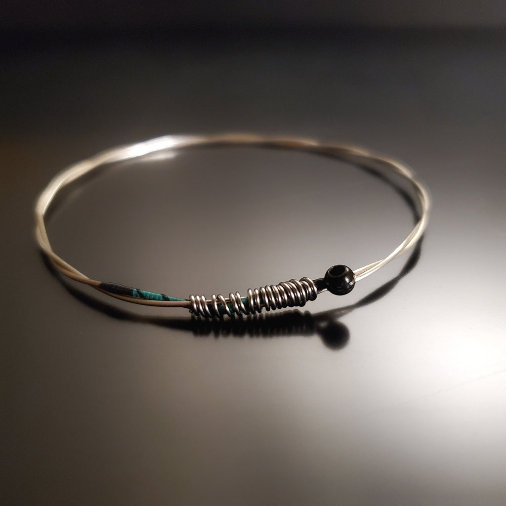 bangle style bracelet made from an upcycled violin