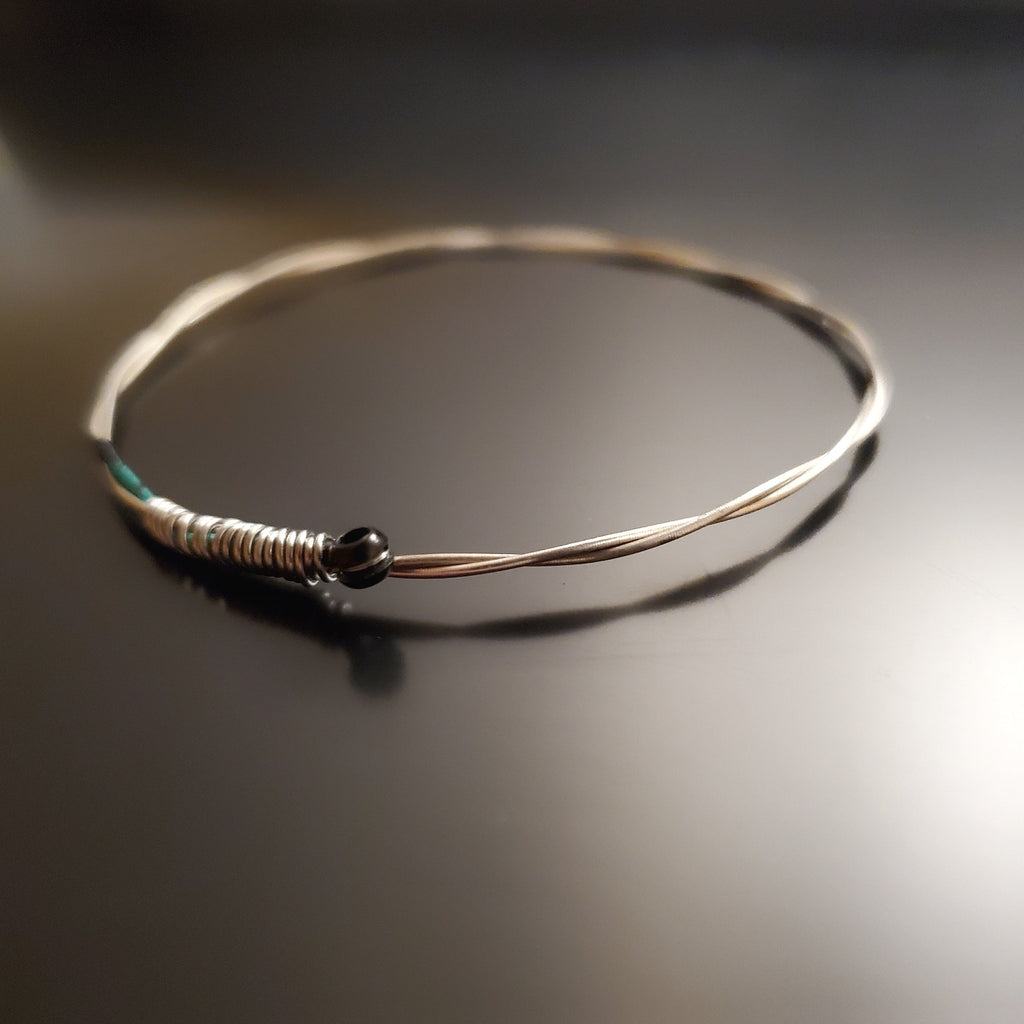 bangle style bracelet made from an upcycled violin