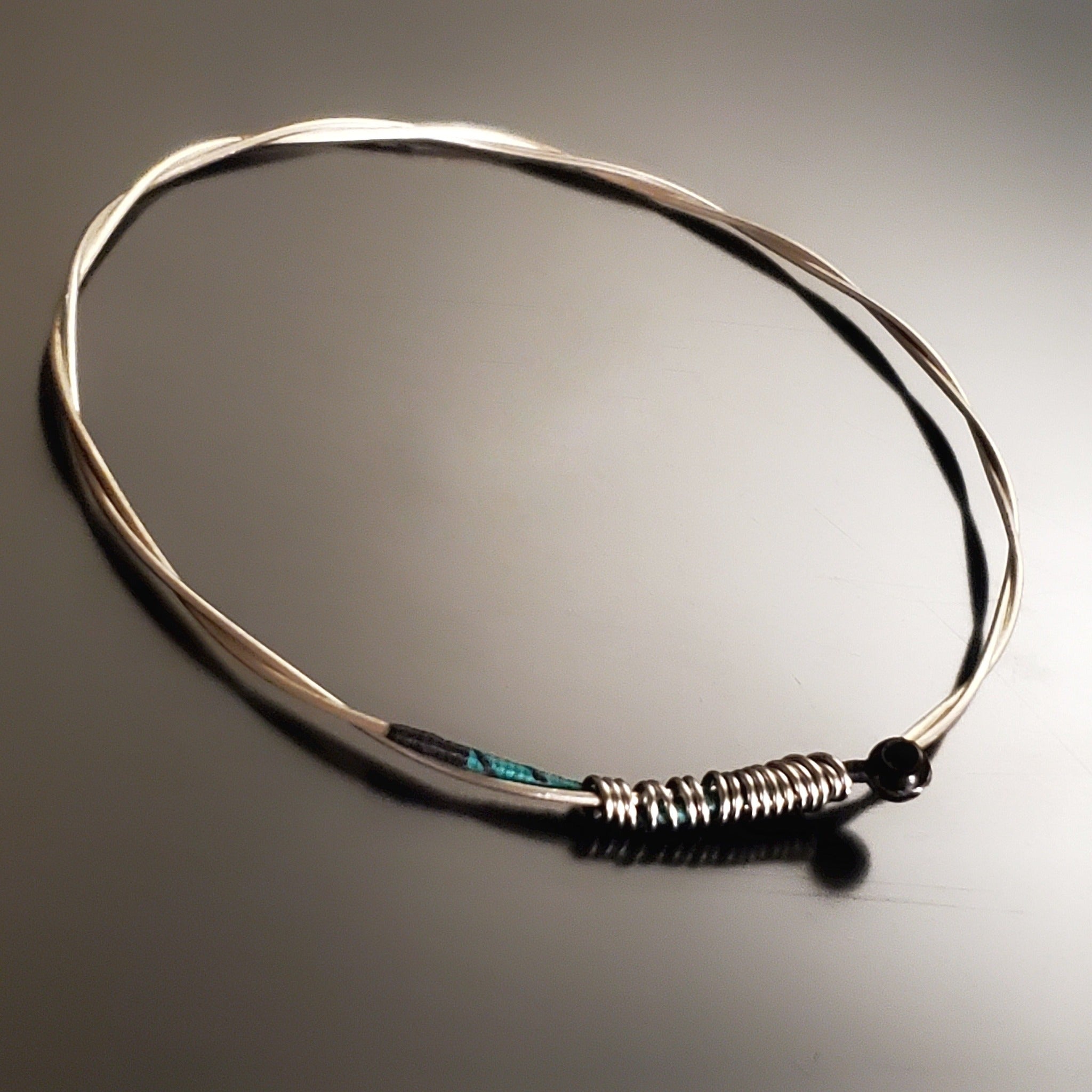 bangle style bracelet made from an upcycled violin