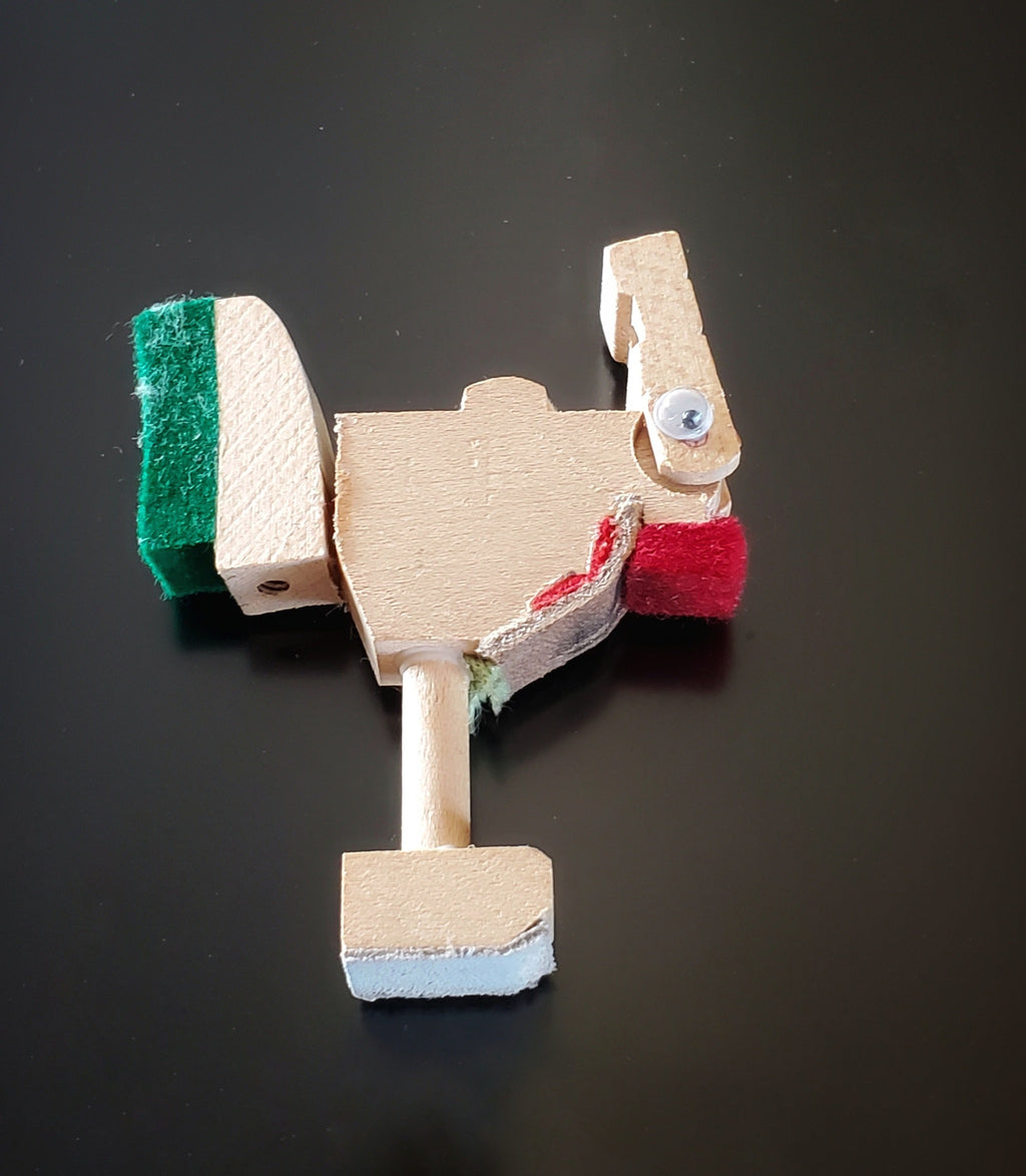 a magnet in the shape of a chicken made from pieces of a piano mechanism