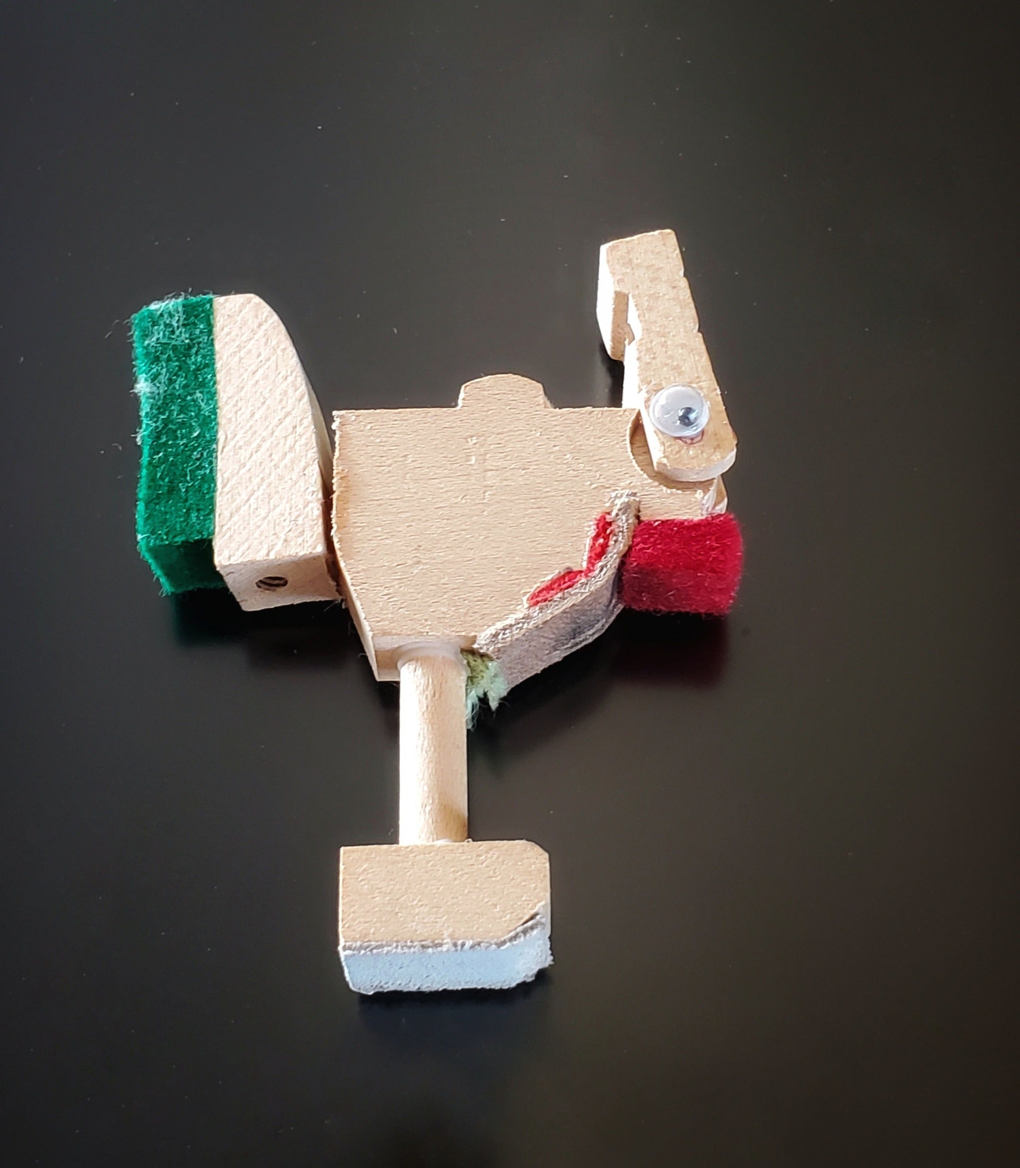 a magnet in the shape of a chicken made from pieces of a piano mechanism