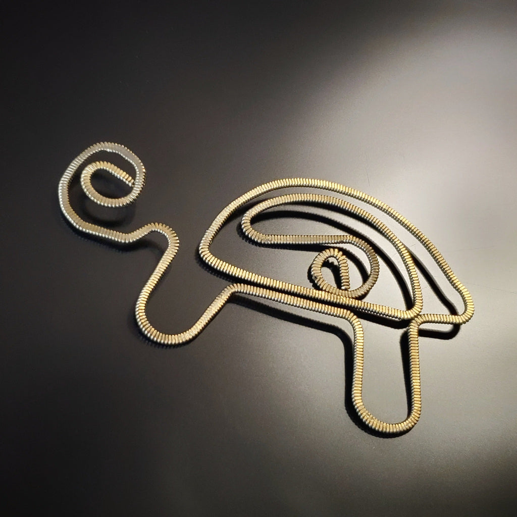 bookmark in the shape of a turtle made from upcycled hammered guitar strings