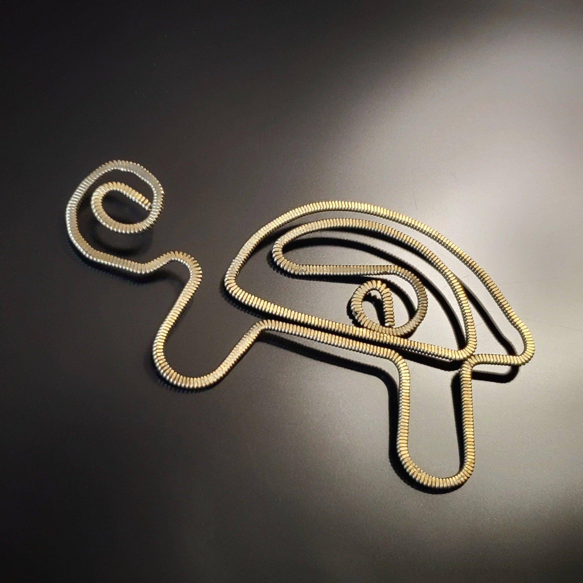 bookmark in the shape of a turtle made from upcycled hammered guitar strings