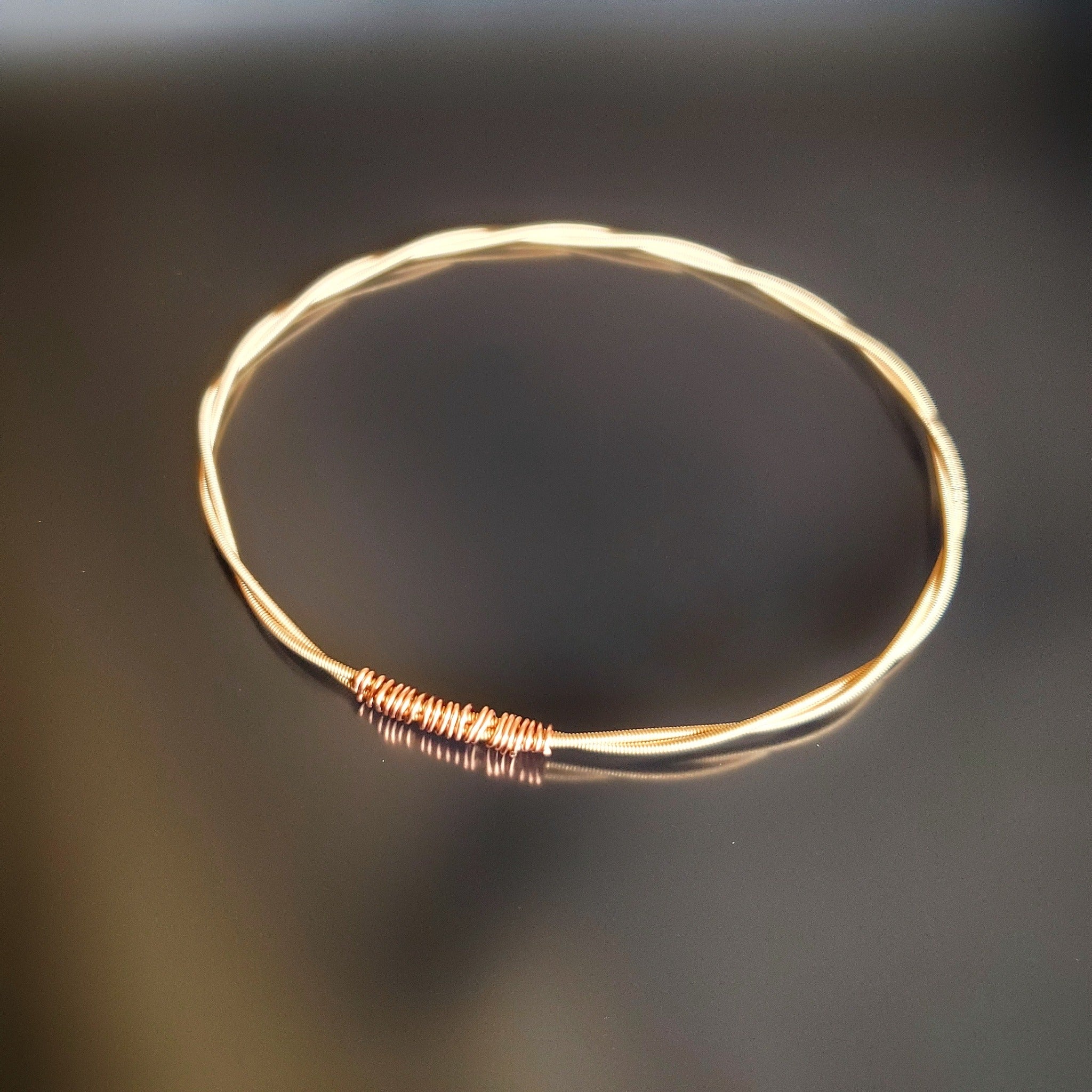 bangle style bracelet made from an upcycled mandolin string 