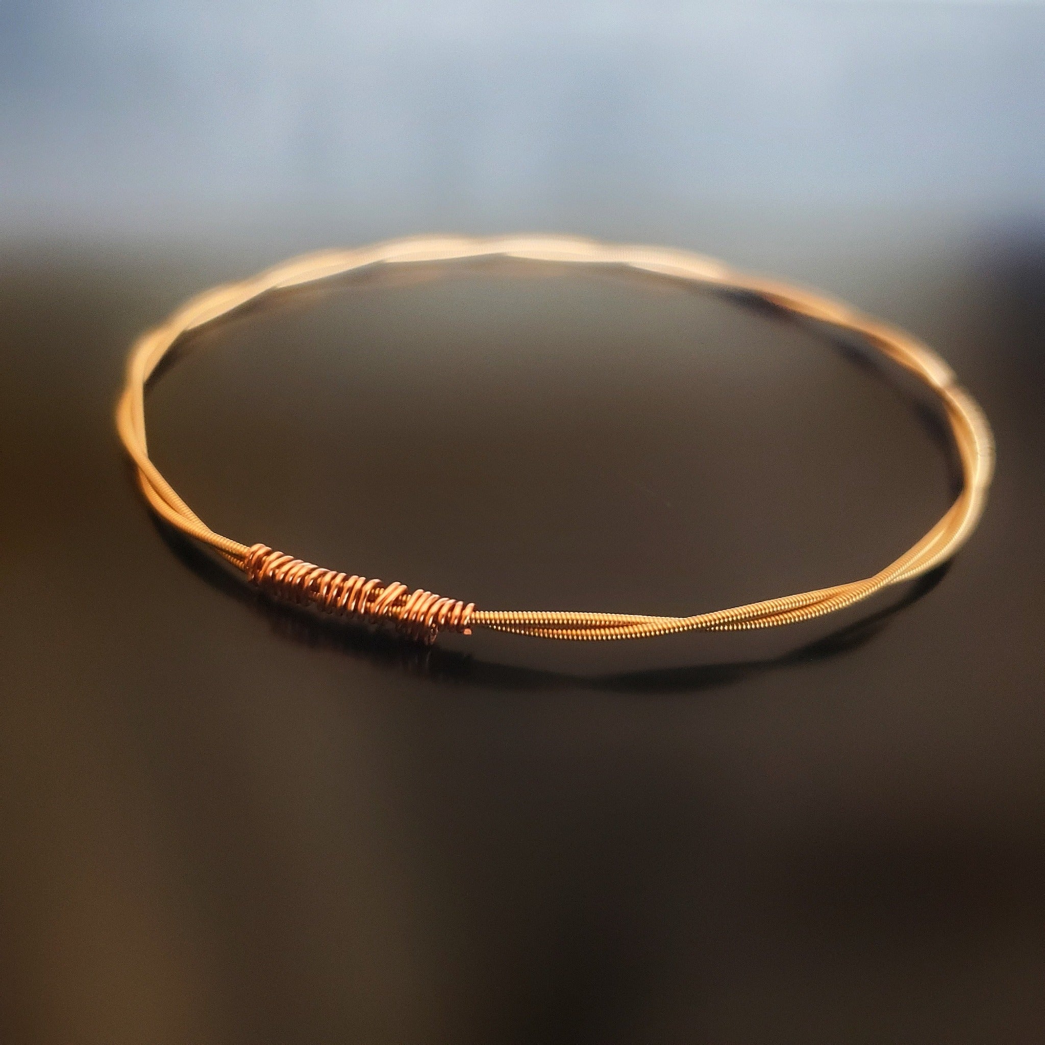 bangle style bracelet made from an upcycled mandolin string