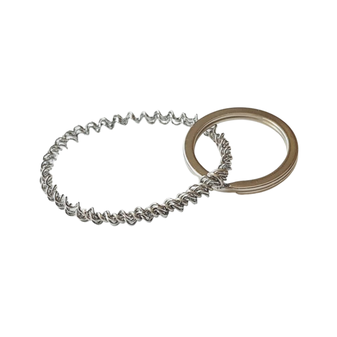 a keychain made from an upcycled snare drum string  - white background