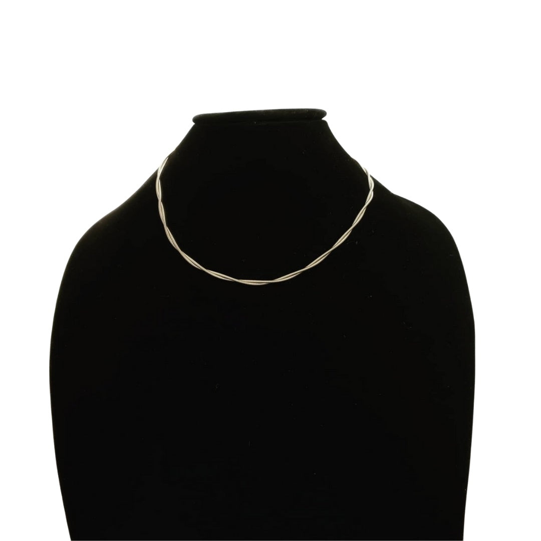 silver coloured guitar strings necklace (two strands twisted together) hung on a black bust with a white background