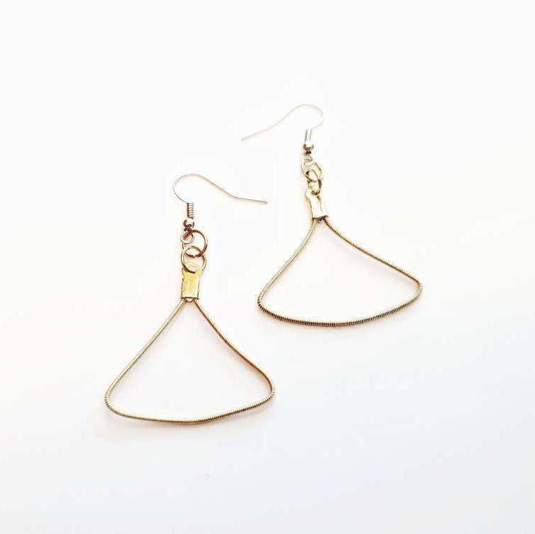 a pair of gold coloured earring made from an upcycled guitar string in the shape of a triangle - white background