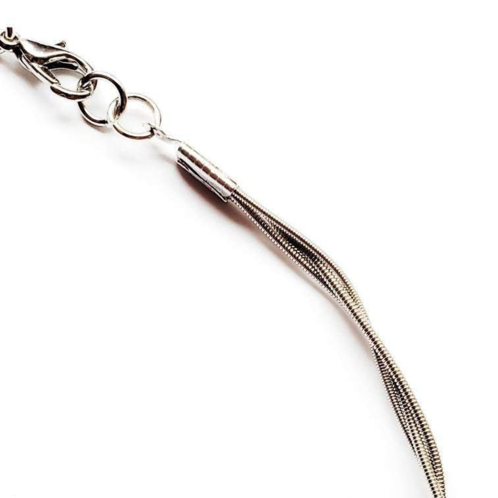 close-up of chain style necklace made from upcycled guitar strings