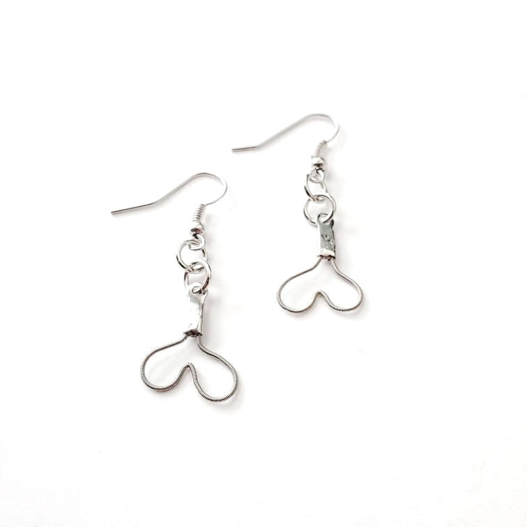 pair of earrings in the shape of upside down hearts, made from upcycled guitar strings - white background